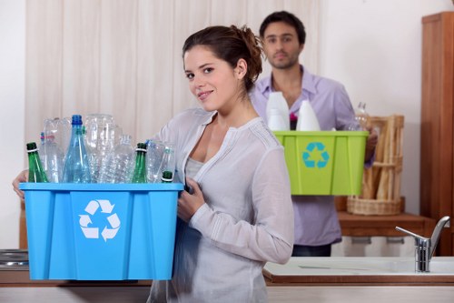 Company van and workers handling commercial waste at a depot
